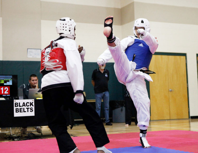taekwondo combat, giving a flying kick